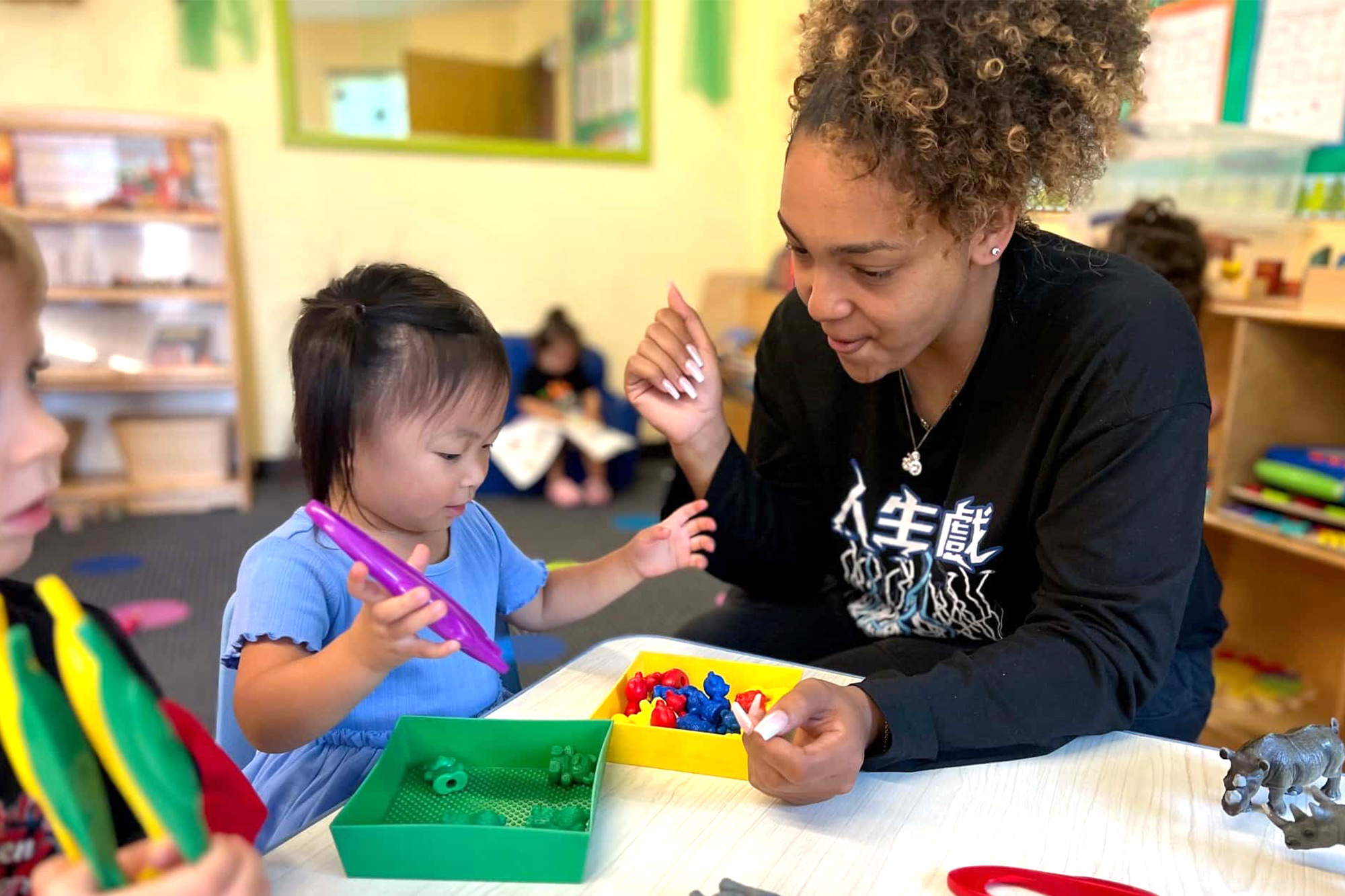Teacher guiding students at Anaheim Preschool