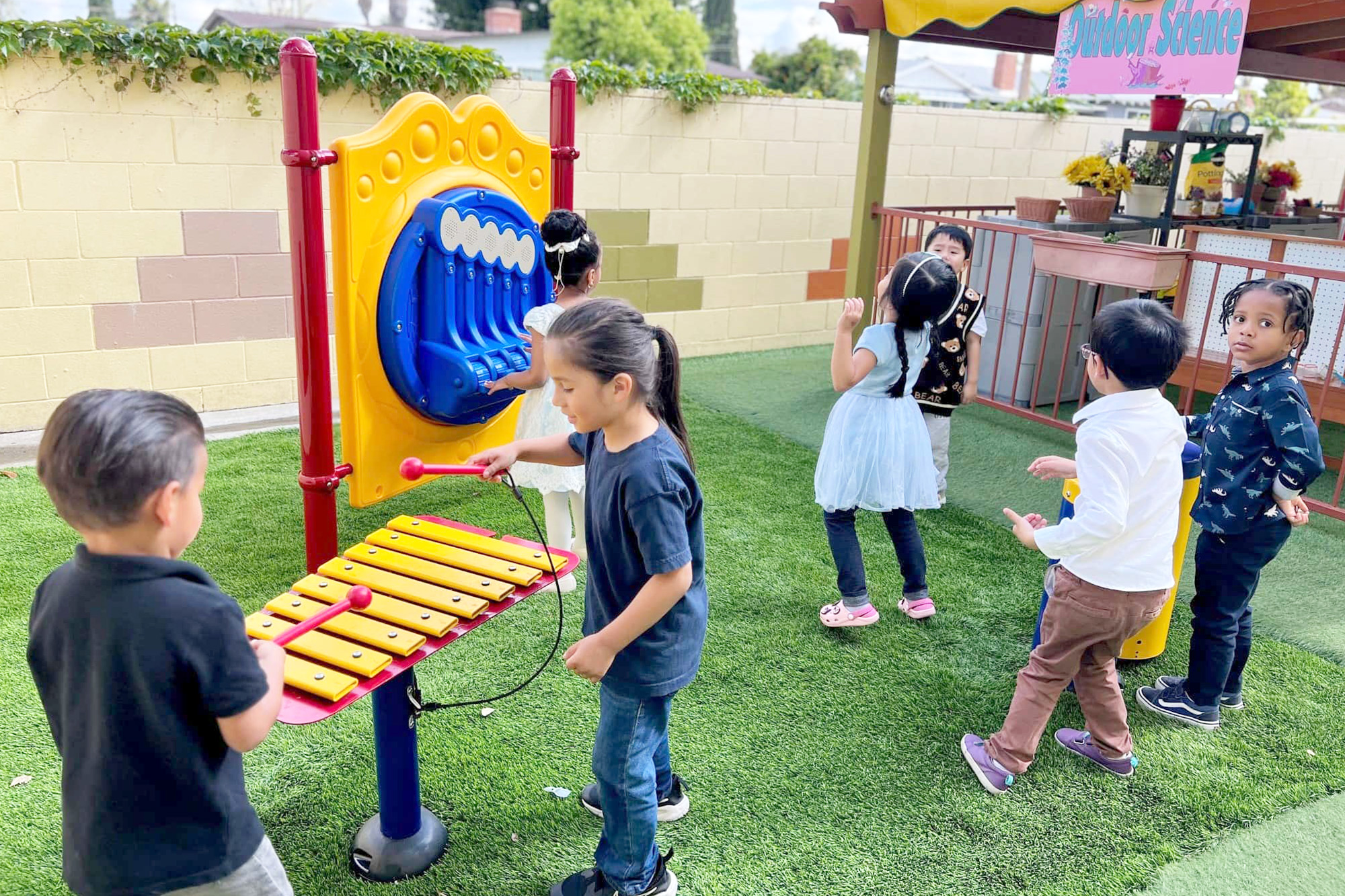 Outdoor Music in Anaheim Preschool with xylophones and sound walls in the play area