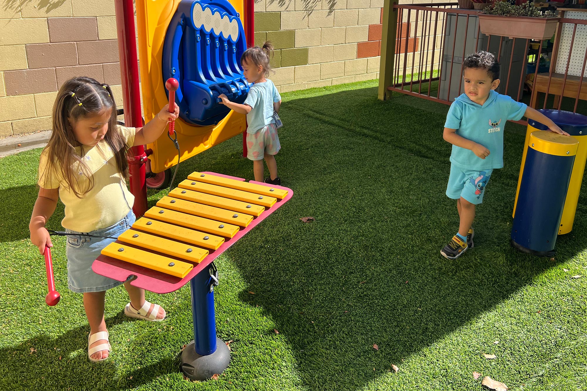 Outdoor Music in Anaheim Preschool with xylophones and sound walls in the play area