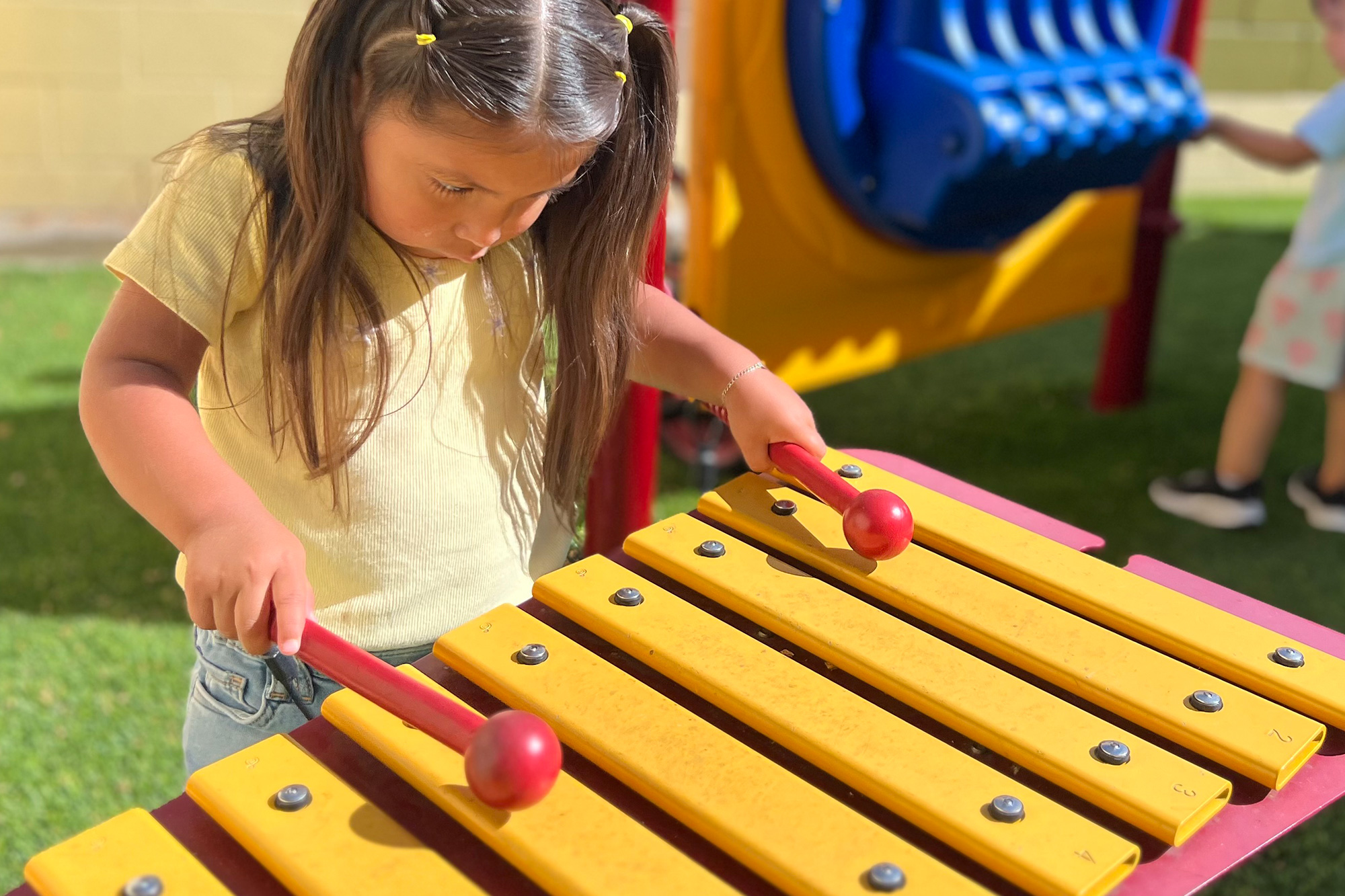 Kids enjoying outdoor music and learning activities at a leading preschool in Garden Grove